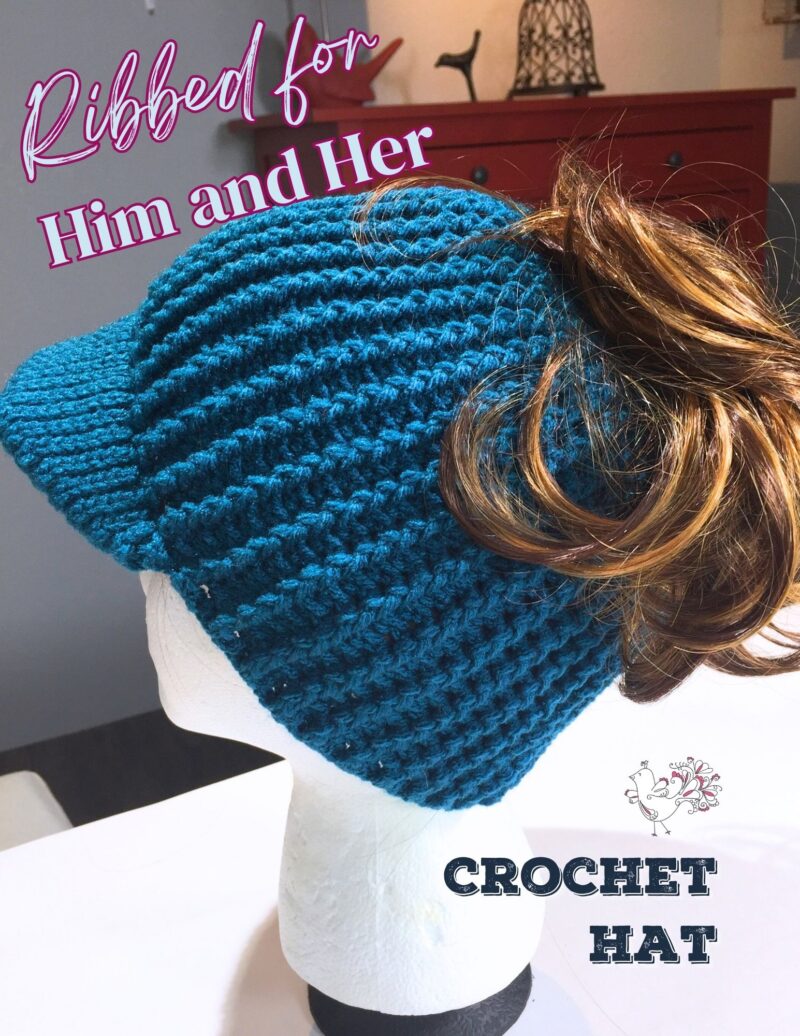 The image depicts a mannequin head displaying a crochet hat with a pronounced ribbed texture. The hat is a vibrant shade of blue, suggesting a cozy, handcrafted feel. Attached to the back of the mannequin head is a brown, curly wig, which cascades down, giving the impression that someone is wearing the hat. The background is a room with warm, inviting tones, and a dresser with a lamp on it. Text overlaid on the image reads "Ribbed for Him and Her" in a playful, cursive font, indicating that the hat's design is unisex. Additional text at the bottom states "CROCHET HAT," clearly labeling the item. A small, whimsical bird-like logo appears at the bottom right corner, possibly representing the brand or creator of the hat.
