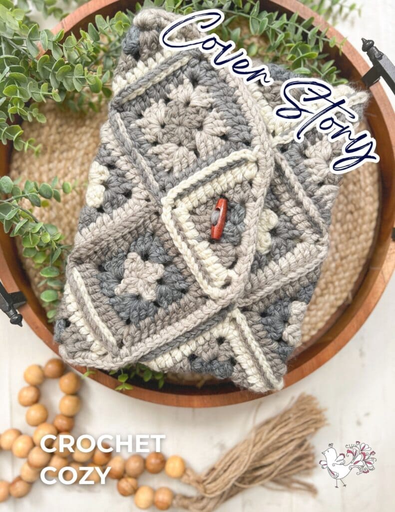 A crocheted cozy featuring a geometric, One Ball Crochet Granny Square Pattern in neutral tones sits in a wooden bowl with greenery, beads, and a tassel. Text reads "Cover Story" and "CROCHET COZY" with a small illustrated logo. -Marly Bird