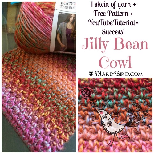 A colorful hand-crocheted cowl with a detailed stitch pattern displayed next to a skein of multicolored yarn and a free pattern booklet titled "Jilly Bean Cowl" by Marly Bird. -Marly Bird