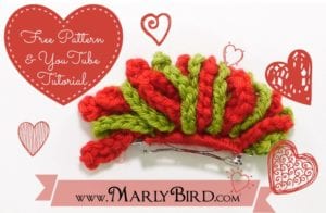 A vibrant green and red crocheted pouch with a clasp, surrounded by decorative hearts and a promotional message for a free pattern and YouTube tutorial at MarlyBird.com, featuring a Miniature Winter Crochet Hat Ornament. -Marly Bird