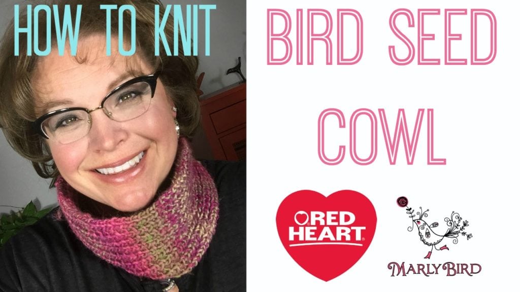 Marly Bird wearing the Bird Seed Cowl in Red Heart Boutique Treasure in colorway Floral (pinks, purples, cream, olive).