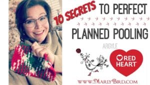 Promotional image featuring a smiling woman holding a multicolored knitted project, with text "10 Secrets to Perfect Planned Pooling Argyle" and logos of Marly Bird and Red Heart. -Marly Bird