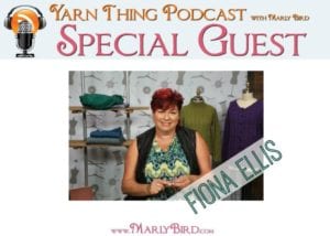 A promotional image for the Yarn Thing Podcast with Marly Bird featuring special guest Fiona Ellis. Fiona is smiling, holding knitting needles with yarn, as she unleashes the power of inspiration with colorful knitwear displayed in the background. -Marly Bird