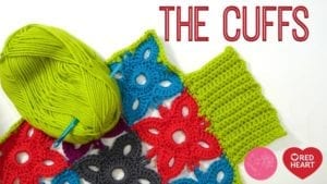 Colorful knitted cuffs display in red, blue, and green with a vibrant skein of green yarn featuring a Marly Bird Granny Square Motif. Text overlay reads "THE CUFFS" and includes the Red Heart brand logo. -Marly Bird