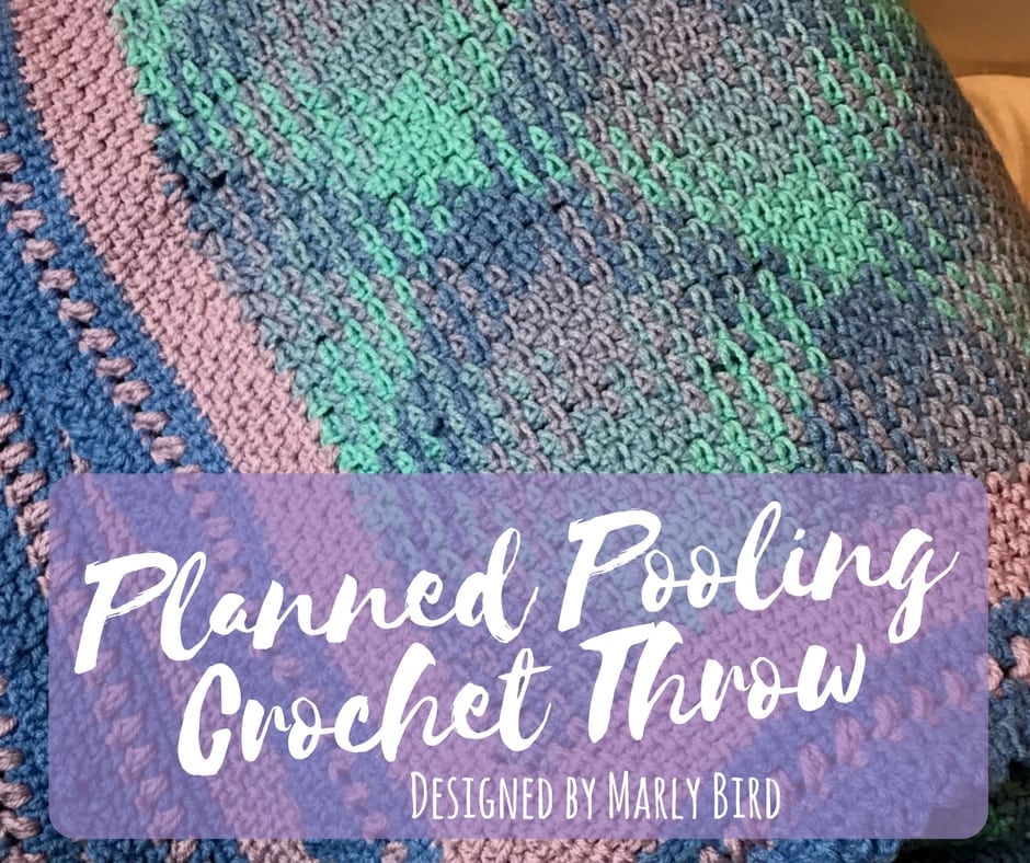 Close-up of a planned pooling crochet throw featuring a multicolored design in green, purple, and pink, with text overlay reading "Planned Pooling Crochet Throw Designed by Marly Bird. -Marly Bird