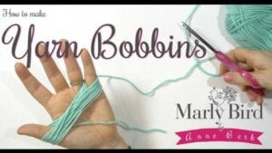 A tutorial image showing hands making Tunisian Crochet yarn bobbins; one hand holds yarn and a pink scissor, with text overlays about the process and instructor's names. -Marly Bird