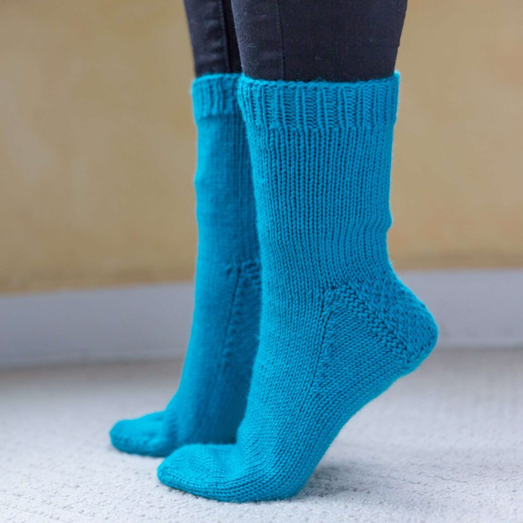 My First Knit Socks in blue yarn