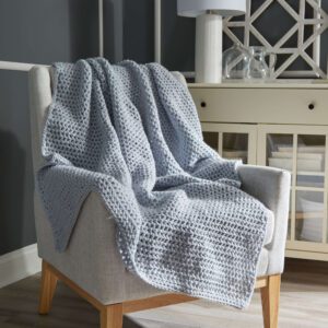 absolute beginner crochet throw blanket draped over a chair. Marly Bird