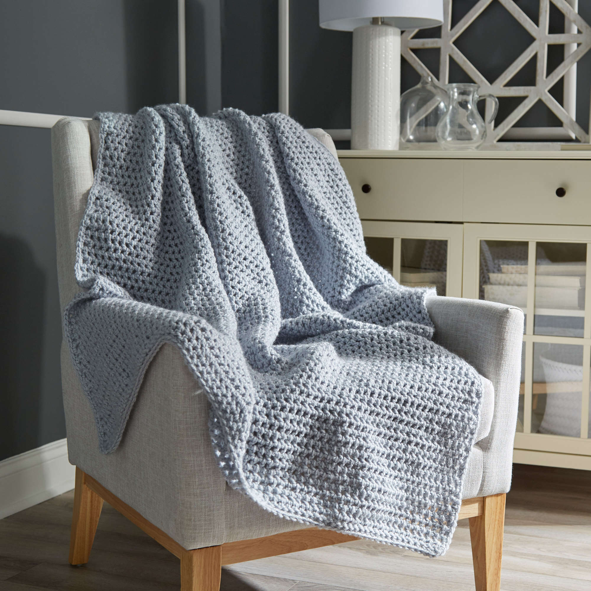 absolute beginner crochet throw blanket draped over a chair. Marly Bird