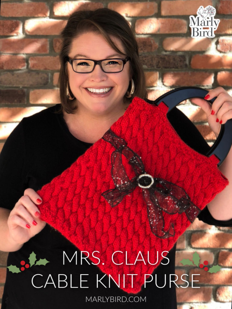 Mrs Claus Knit Purse is red and made with knit cables.