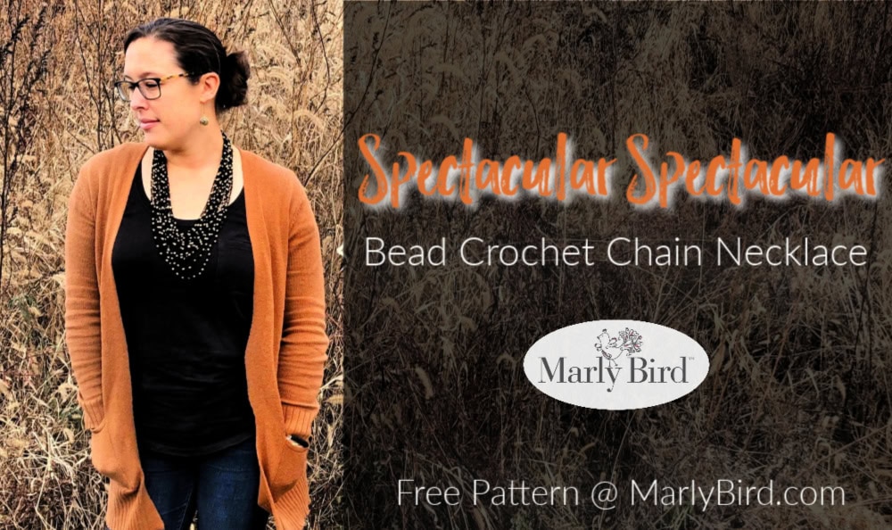 Bead Crochet Chain Necklace | Free Crochet Pattern by Marly Bird. Model wearing jeans, black scoop neck tee, and orange cardigan, with black and gold beaded crochet necklace.