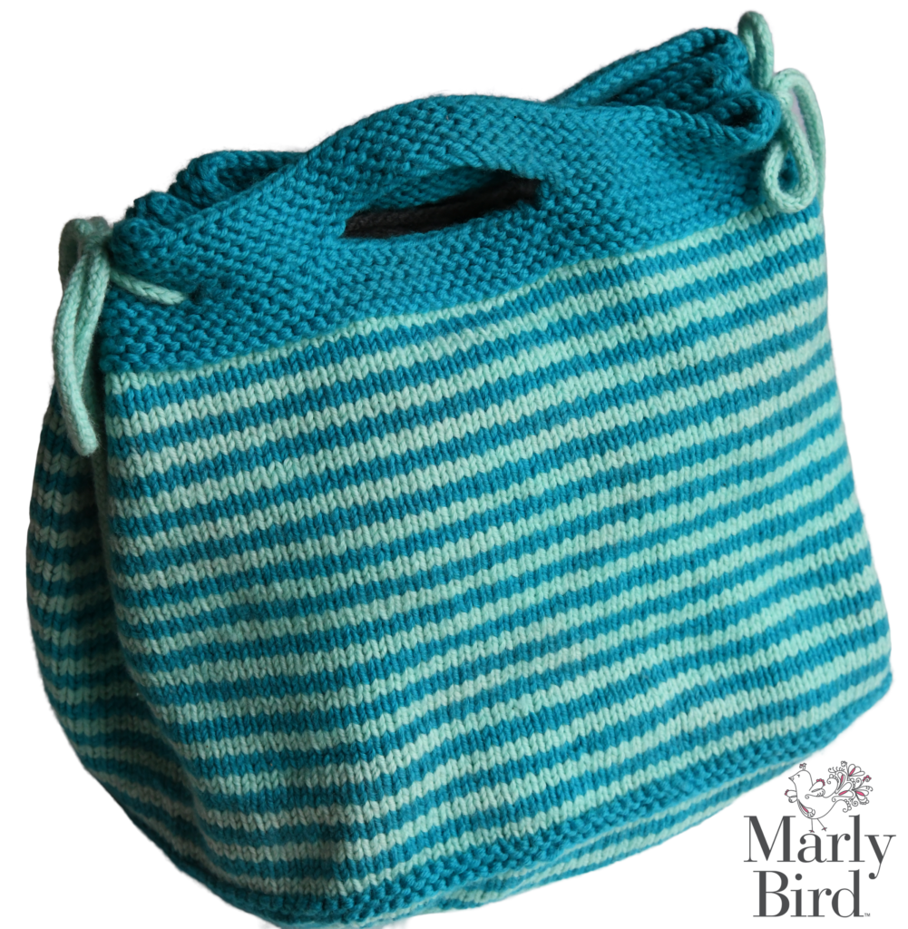 vacation knit project bag in teal and mint green. small handle opening and icord tie closure on the corners. Free Knit Bag Pattern on Marly Bird website.