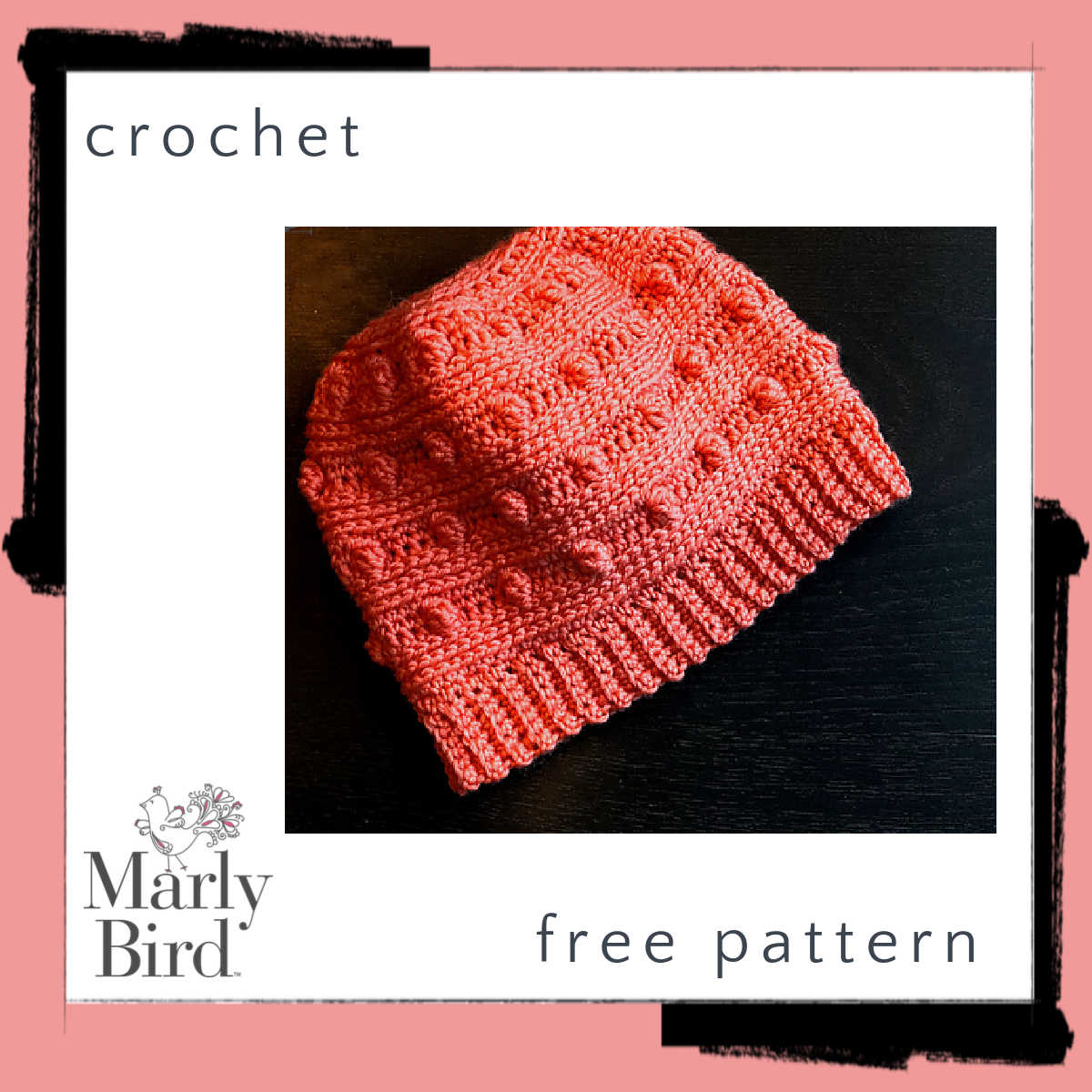 Bobble crochet hat pattern: coral colored crochet hat with alternating stripes of bobbles and knit-look stitches, on dark background.