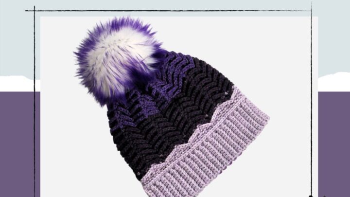 Purple, black, and lavender Tunisian crochet hat with faux fur pom-pom; project name "Wings of Hope Hat" above. Logo in corner.