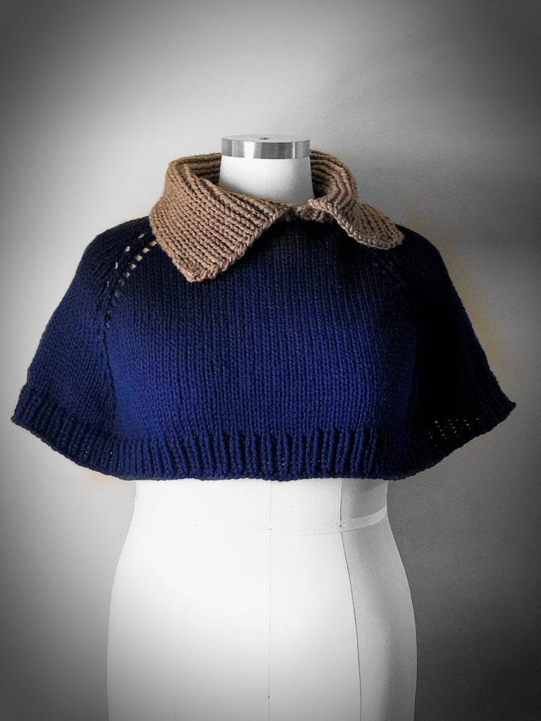 shoulder hug capelet in navy blue yarn body and brown collar on a mannequin -- Marly Bird
