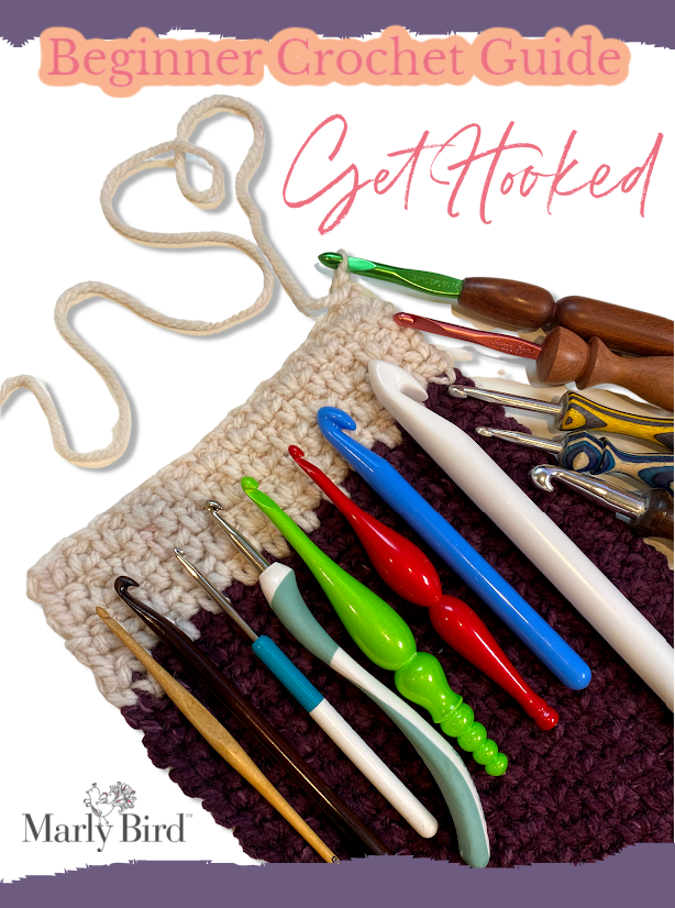 Variety of hooks laying on a crocheted fabric and the words 'get hooked' - Marly Bird
