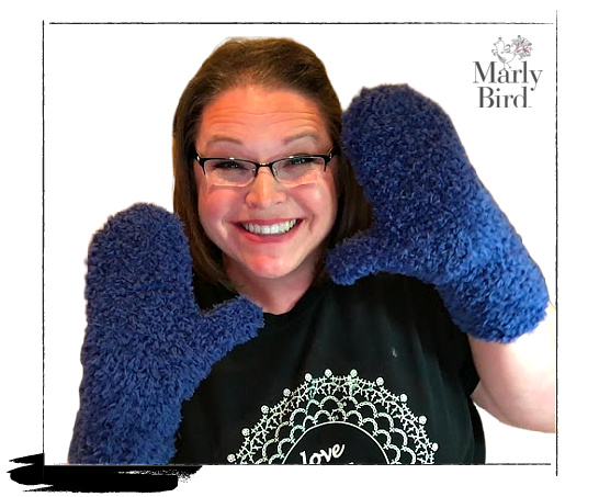 marly bird wearing the blue fur real mittens showing the fit of the crochet mittens