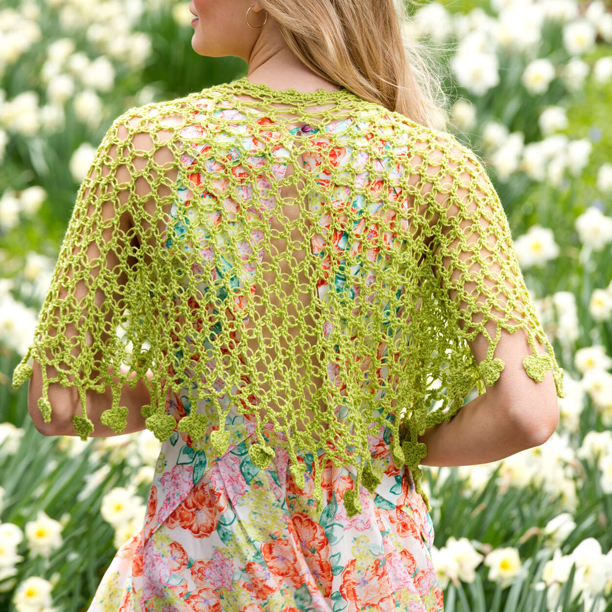 crochet love knot shawl draped over the shoulders of a blonde woman. image shows the back of the model - Marly Bird