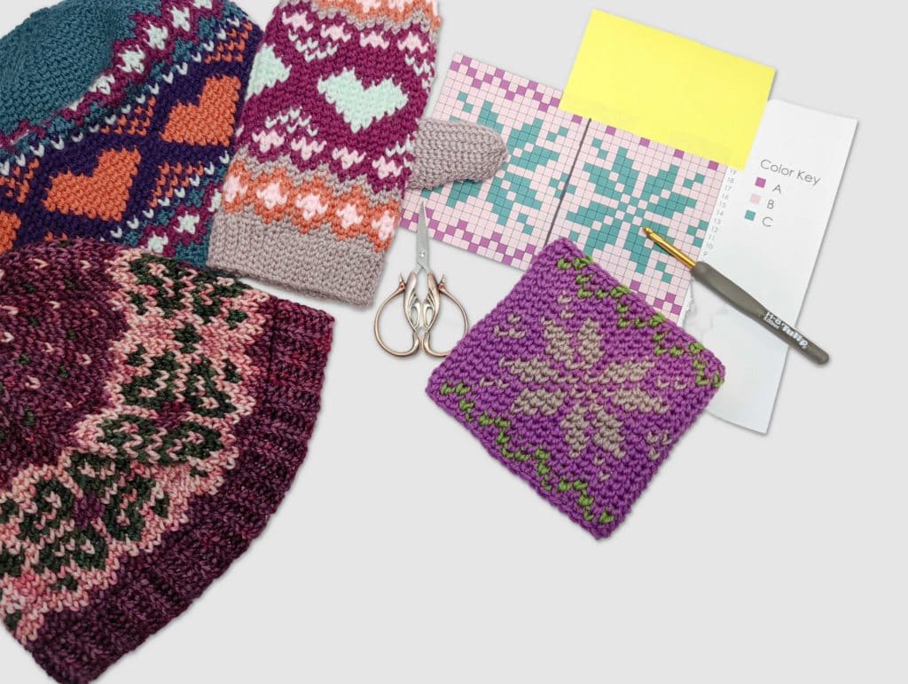 Knitted hats, a mitten, and a textured purple swatch with geometric patterns are shown with charts and crochet tools for reference.