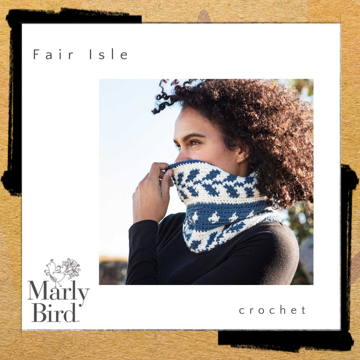 Curly haired model wearing fair isle crochet cowl in cream and green stitch pattern. Marly Bird