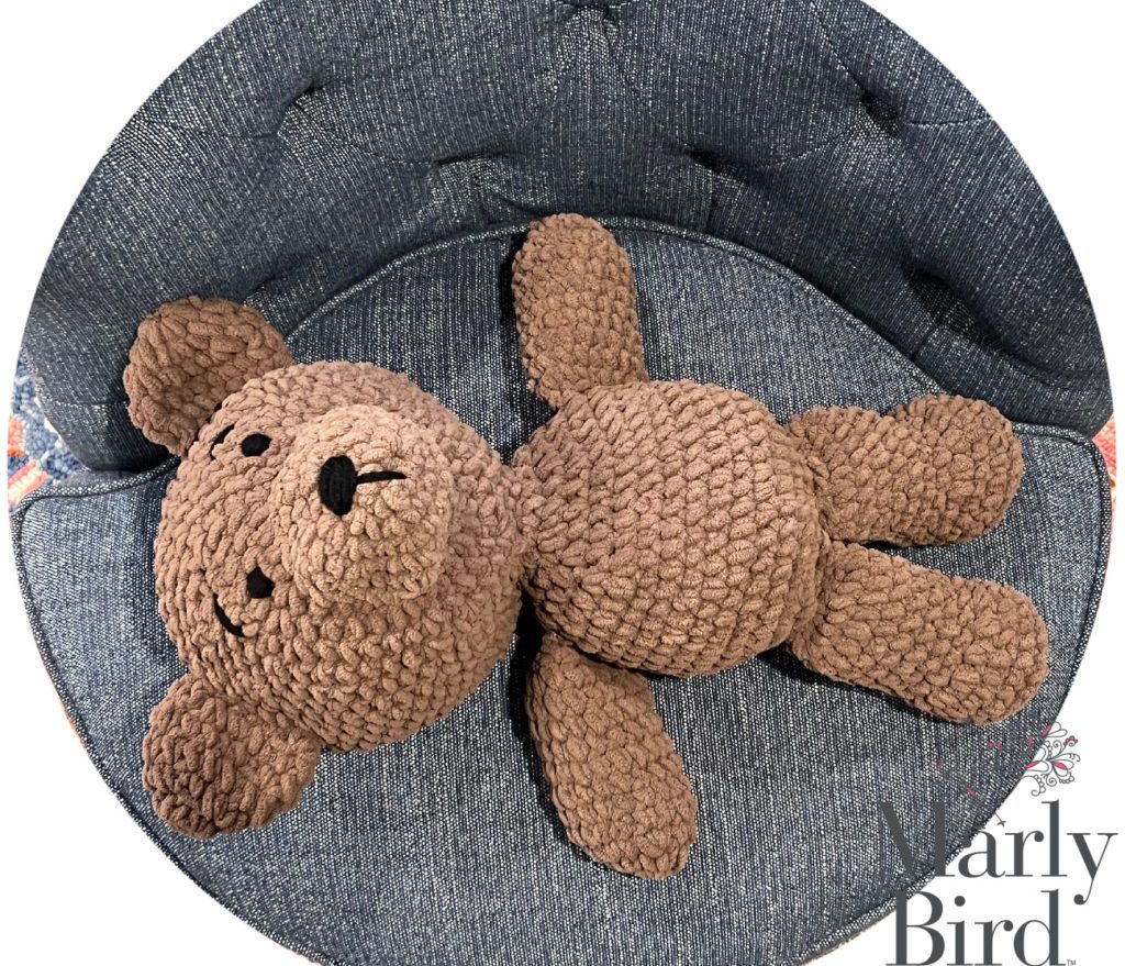 Picture of the Big Teddy Bear laying flat on a chair. Free Crochet Stuffed Animal Pattern.