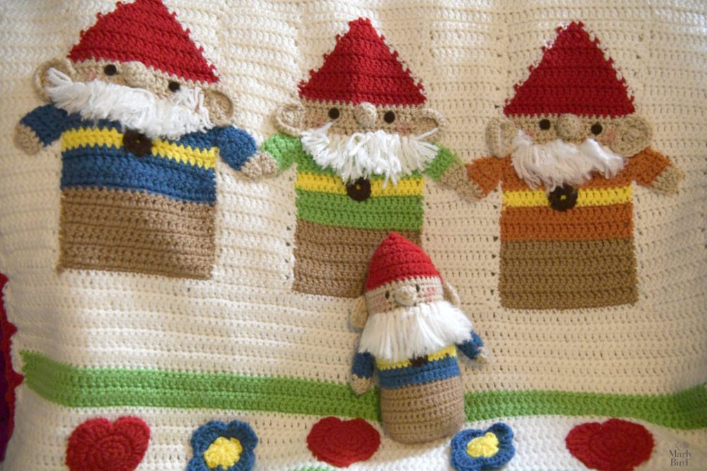 Gnome crochet blanket close-up with crochet gnome doll.