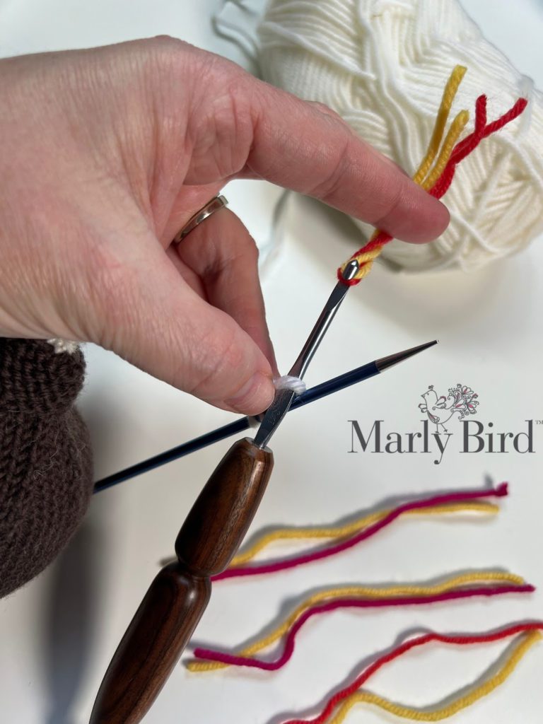 STUFFED KNIT F-BOMB PATTERN by Marly Bird adding tassels to the loops of the i-cord. 
