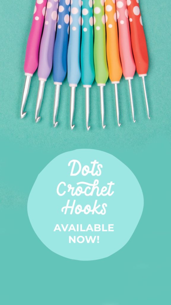 Set of Dots Crochet Hooks at top of image with hooks pointed down, on blue background. Gifts for crocheters. Marly Bird