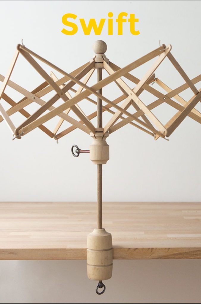 Wooden yarn swift clamped on light colored wood table against white wall. Gifts for crocheters - Marly Bird