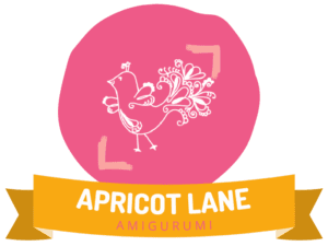 Apricot Lane Amigurumi Image. Marly Bird Logo in a pink circle over a banner that reads Apricot Lane Amigurumi