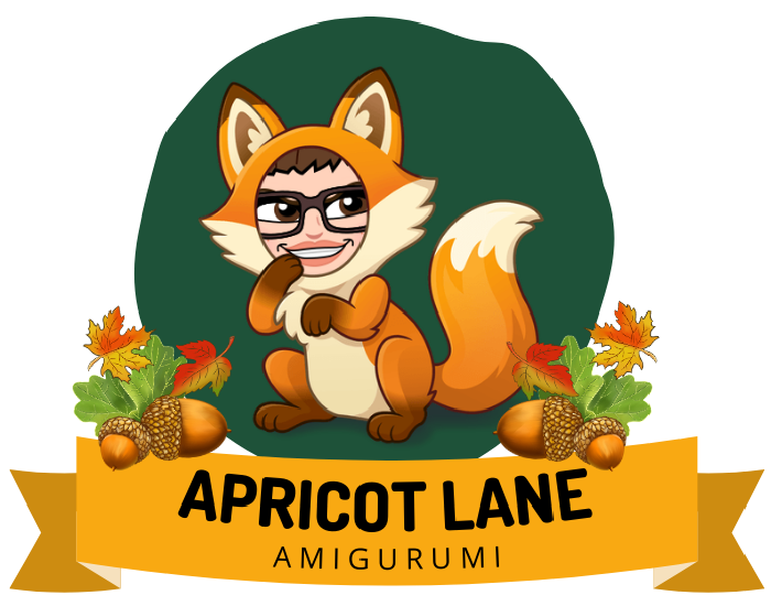 Apricot Lane Amigurumi Image. Marly Bird Bimoji in a fox outfit in a dark green circle over a banner that reads Apricot Lane Amigurumi