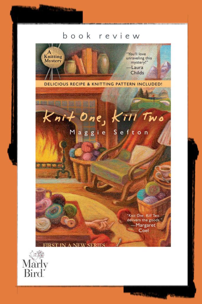 Knit One Kill Two - Book cover showing a rocking chair and yarn by a fire with an arm appearing behind the table laying on the ground.