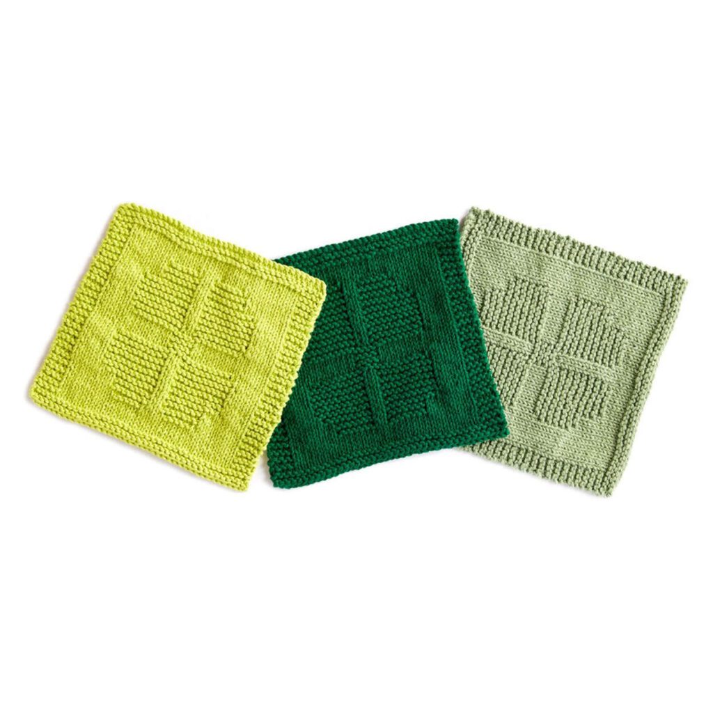 free knit and crochet saint patrick's pattern. picture of 3 dishcloths with garter stitch four leaf clover in the center of the dishcloth surrounded by stockinette stitch. Marly Bird
