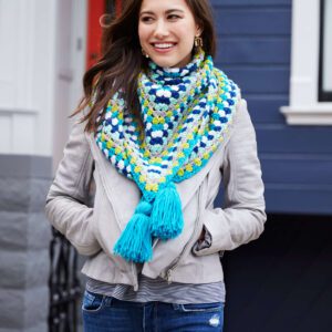 Shivering Chic Shawl wrapped around the neck and shoulders of a brunet model. The shawl is a granny stitch triangle in modern colors - Marly Bird