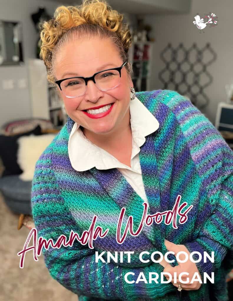 A person wearing glasses smiles warmly, dressed in a colorful knit cocoon cardigan. The text reads "Amanda Woods Knit Cocoon Cardigan." A cozy living room setting is visible in the background. -Marly Bird