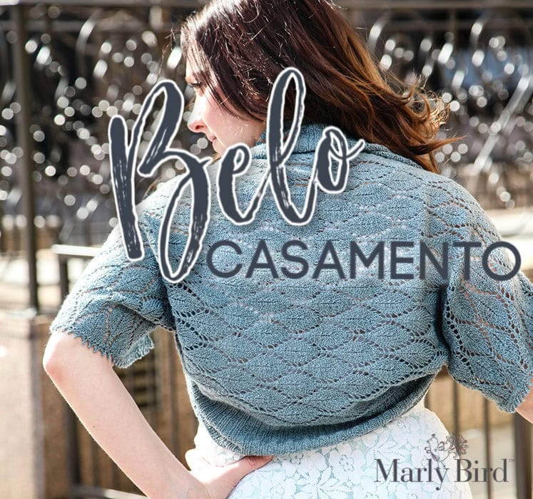 A woman with long brown hair wears a light blue, lacy knit shrug outdoors. "Belo Casamento" is overlaid in large script, with "Marly Bird," a small bird logo, and mention of free knitting and crochet patterns in the bottom right corner. -Marly Bird