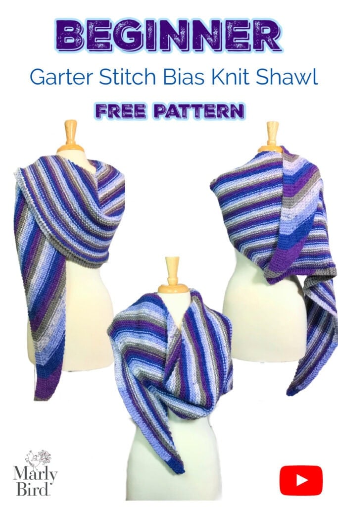 Colorful Garter Stitch Bias Shawls in purple, blue, white, and gray are draped on three mannequins, showing knit texture.