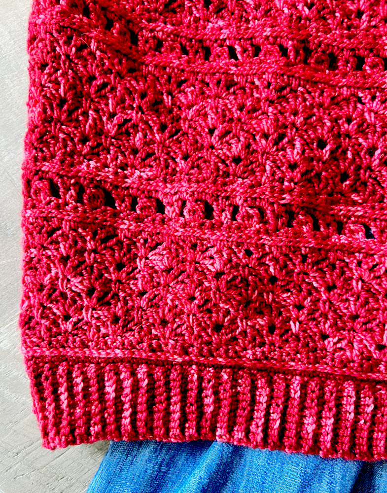 Super close-up image of Bellini Sweater crochet stitches and bottom rib.