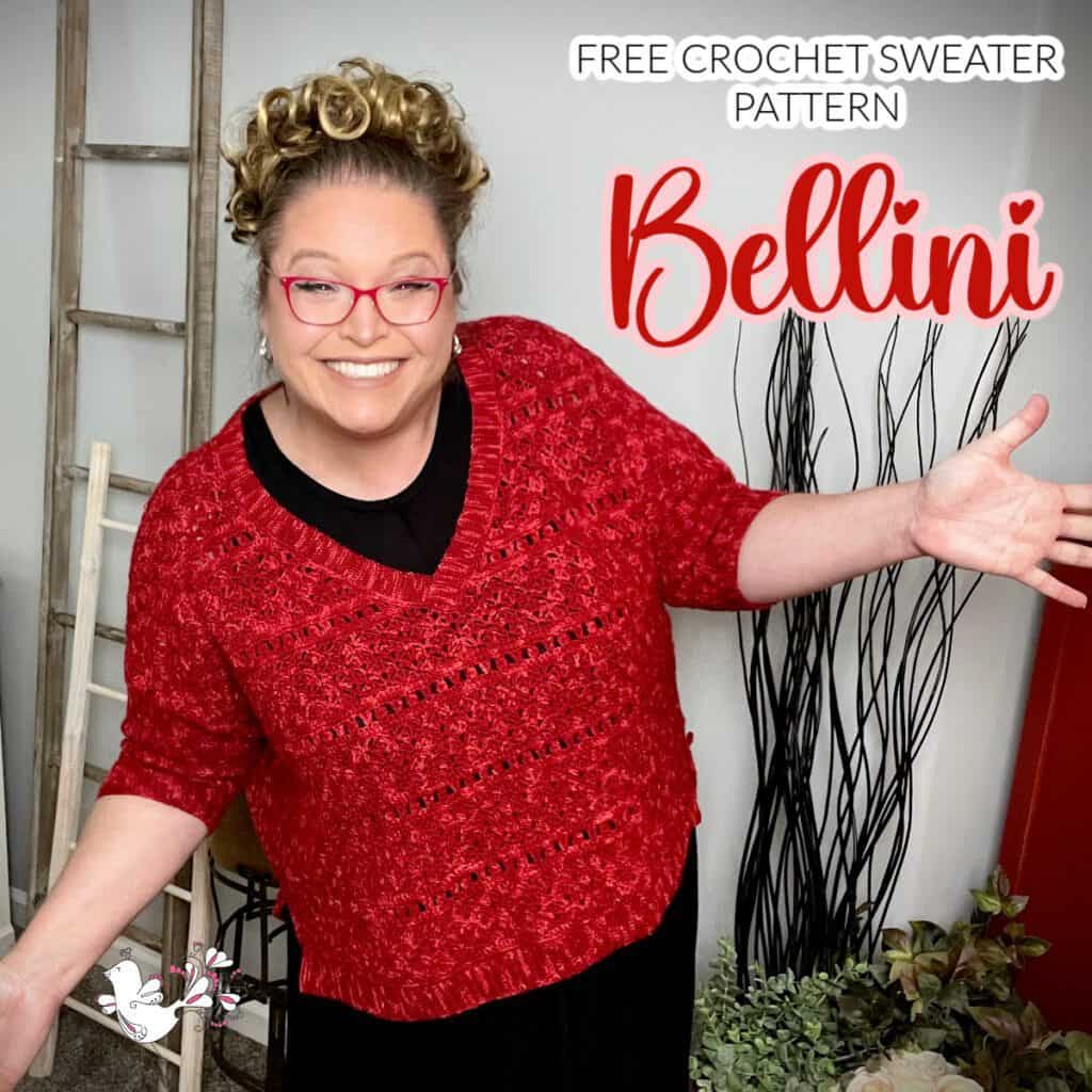 A smiling person with curly hair and red glasses is wearing a red bellini crochet sweater. They are standing with their arms open. Text on the image reads: "FREE CROCHET SWEATER PATTERN" and "Bellini." A small illustration of two cartoon rabbits is at the bottom left. -Marly Bird