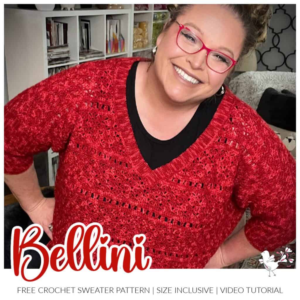 A smiling person wearing red glasses and a crocheted red sweater showcases the stunning "Bellini Crochet Sweater." The image promotes a free crochet sweater pattern called "Bellini." Below the sweater name, it states "Free Crochet Sweater Pattern | Size Inclusive | Video Tutorial." A small dove drawing is also visible. -Marly Bird