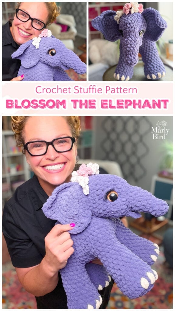 Purple crocheted elephant amigurumi with a flower on its head, held by a person wearing glasses.