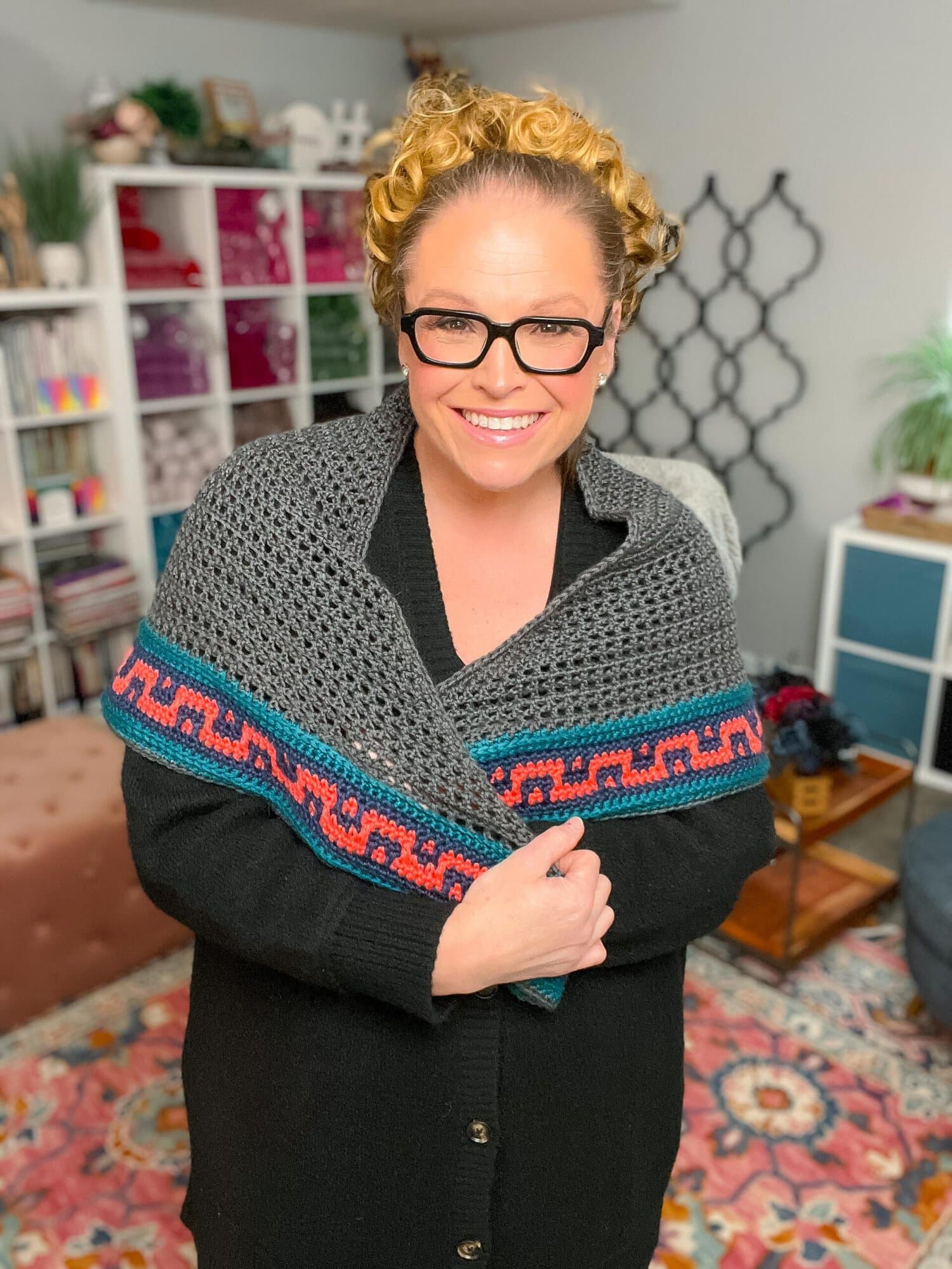 Coral Ridge free crochet triangle shawl pattern modeled — gray shawl with blue and red Greek-key colorblock border by Marly Bird and Robyn Chachula