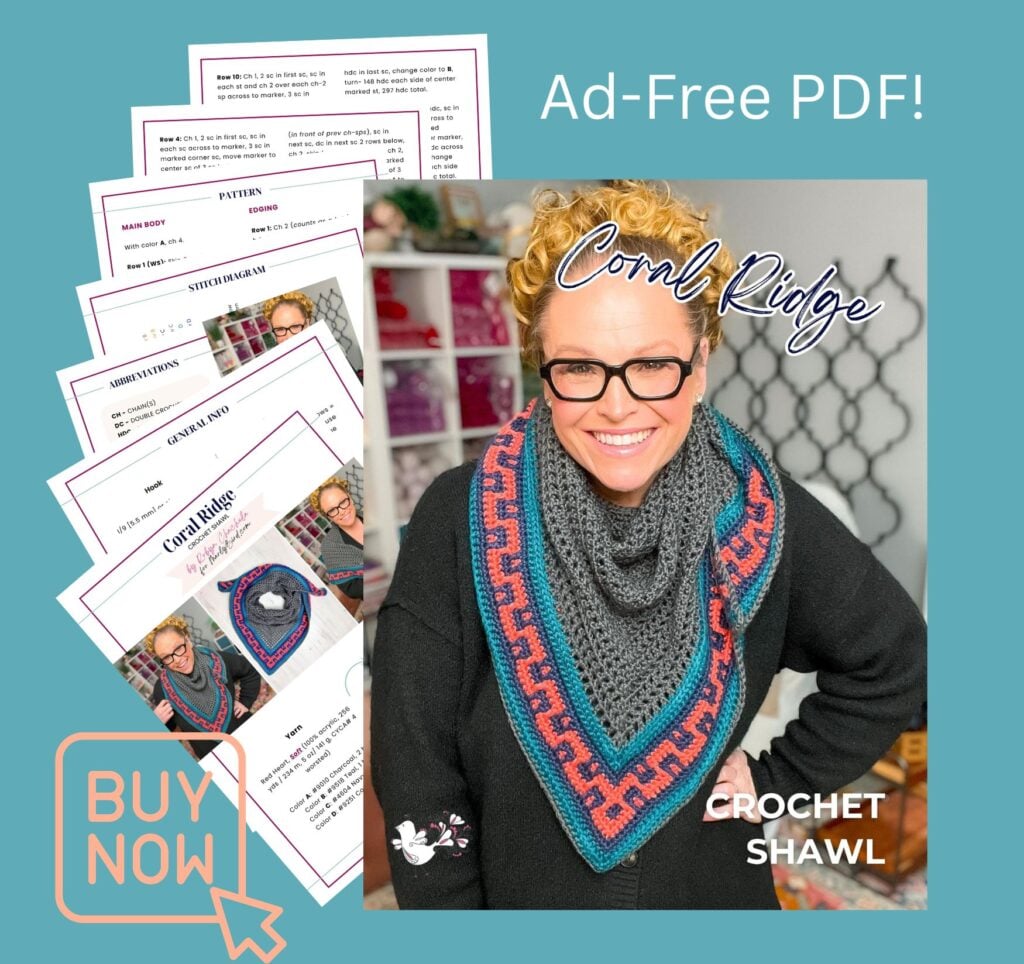 Ad-free PDF of the Coral Ridge Crochet Shawl free pattern — Marly Bird modeling the worsted weight crochet triangle shawl with colorwork Greek-key border in front of her yarn studio shelves