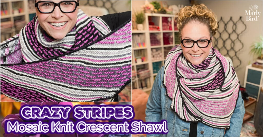A smiling person wearing glasses models a Knit Crescent Shawl with colorful, striped mosaic patterns in pink, purple, black, and white. Text reads "Crazy Stripes Mosaic Knit Crescent Shawl." Shelves of yarn fill the background. -Marly Bird