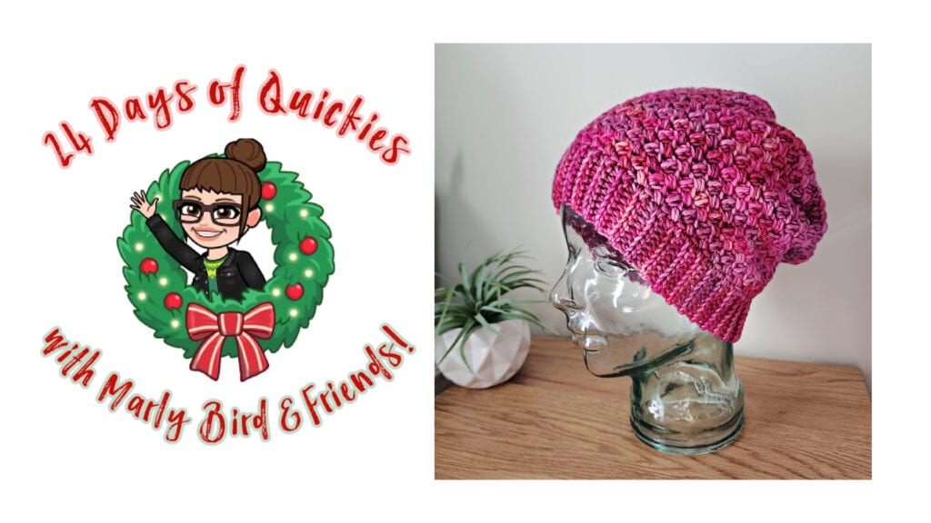 A logo reading "24 Days of Quickies with Marly Bird & Friends!" surrounds a cartoon woman in a festive wreath, celebrating the 24 days of quickies next to a pink crocheted hat on a glass head atop a wooden surface. -Marly Bird