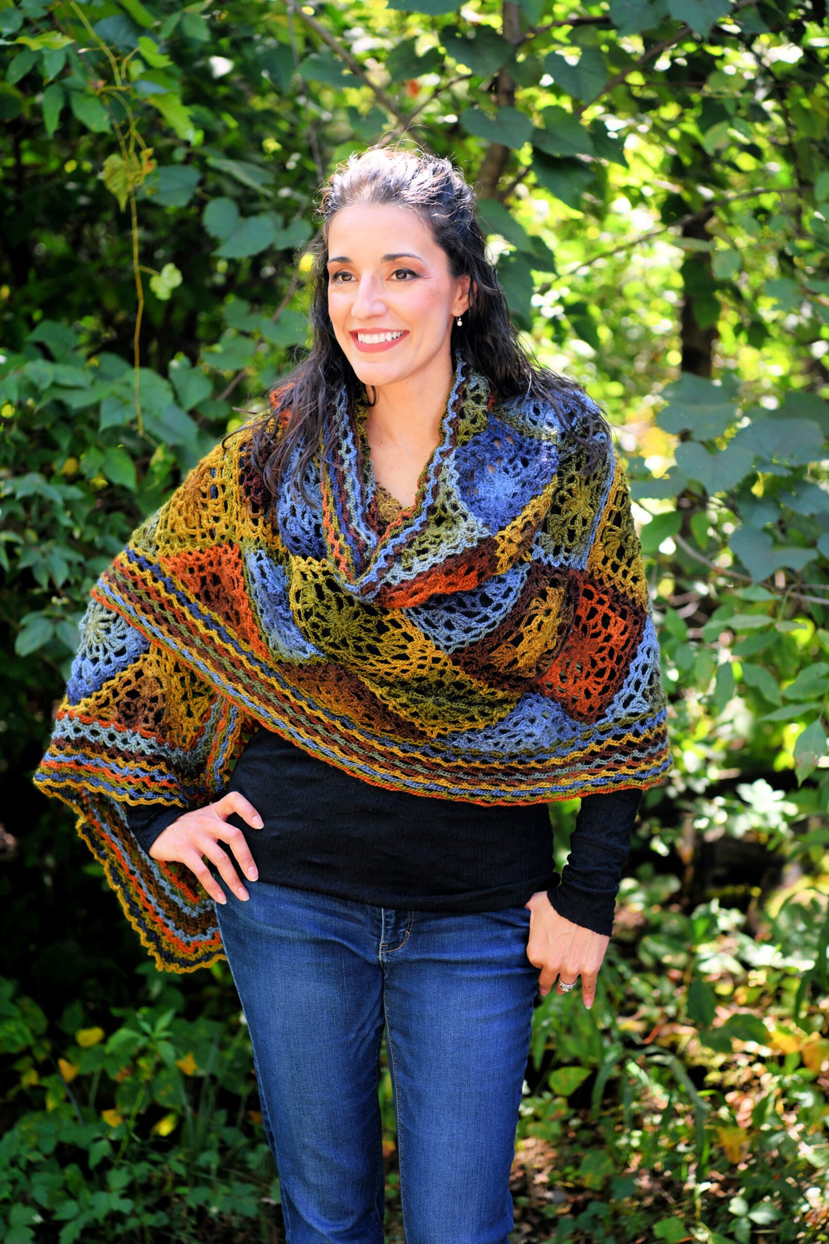 Red Heart Unforgettable yarn in woodland, rectangular crochet shawl named Enchanted is draped around the shoulders of a model to show off the colors and the stitches of this free pattern and ad-free pdf - Marly Bird