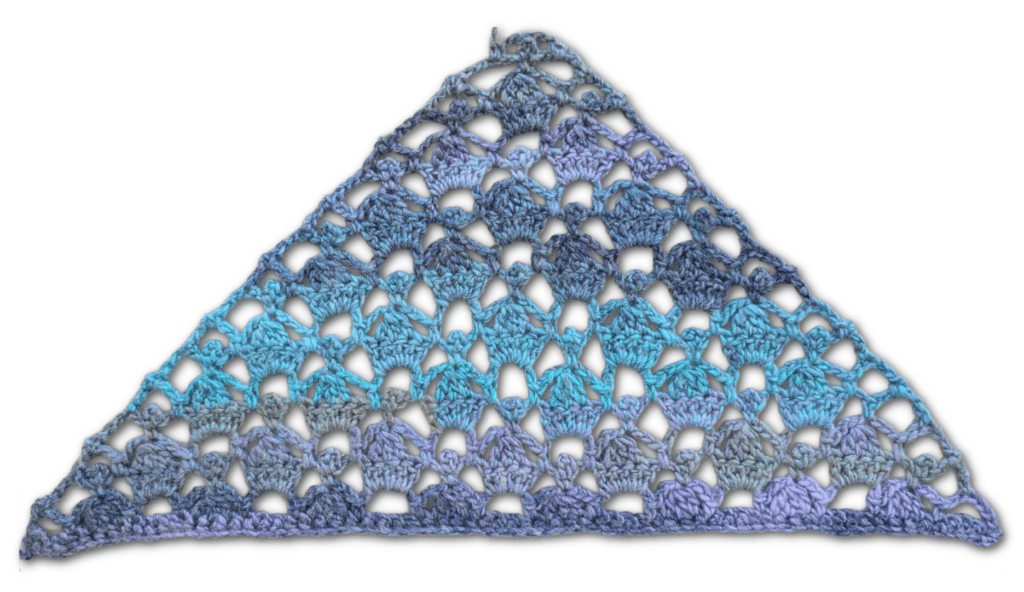 Triangular crochet shawl with lacy open shell stitches, using blue, purple, and gray yarns that softly blend throughout.
