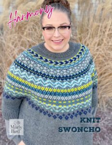 A smiling woman with her hair styled in an updo, wearing glasses and a colorful knit swoncho. The words "harmony" and "Marly Bird knit swoncho" appear as text overlays. -Marly Bird