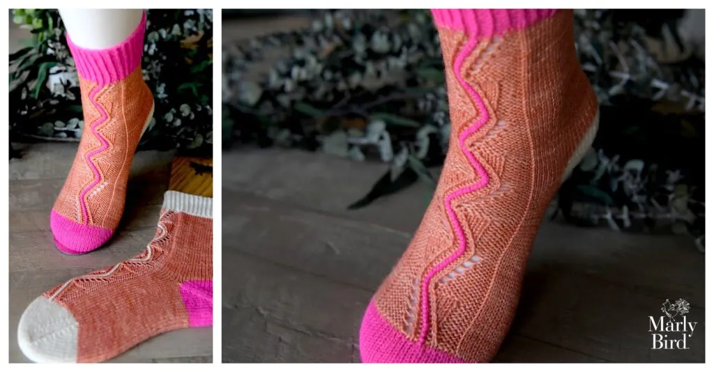 Side and close-up of an orange knit sock with pink toe, heel, and cuff; wavy white and pink lines along the sides. Displayed on a mannequin.
