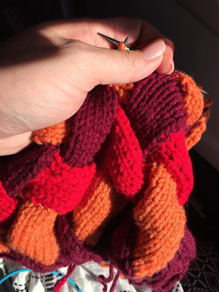 knitting entrelac with addi turbo knitting needles on a plane - great knitting project for travel - Marly Bird